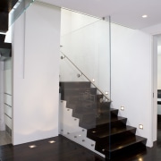 View of a stairway with glass balustrade and floor, flooring, glass, handrail, interior design, stairs, wall, white