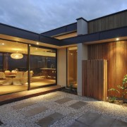 Exterior view of house featuring cladding, roofing, landscaping. architecture, estate, facade, home, house, interior design, lighting, property, real estate, window, brown