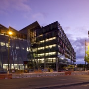 Exterior view of the Bendigo Bank sustainable building apartment, architecture, building, city, commercial building, condominium, corporate headquarters, downtown, evening, facade, home, hotel, house, metropolis, metropolitan area, mixed use, neighbourhood, night, real estate, reflection, residential area, sky, town, urban area, purple