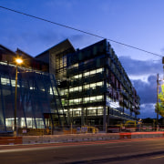 Exterior view of the Bendigo Bank sustainable building apartment, architecture, building, city, cityscape, commercial building, condominium, corporate headquarters, downtown, evening, facade, headquarters, home, house, metropolis, metropolitan area, mixed use, neighbourhood, night, real estate, reflection, residential area, sky, street, tower block, town, tree, urban area, blue