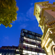Exterior view of the Bendigo Bank sustainable building architecture, building, city, daytime, facade, landmark, light, metropolis, metropolitan area, mixed use, night, reflection, sky, skyscraper, tree, urban area, yellow, brown, blue