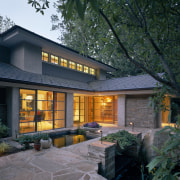 Image of the exterior of this contemporary new architecture, cottage, courtyard, estate, facade, home, house, landscape lighting, lighting, property, real estate, residential area, siding, window, black