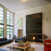 Image of the living room featuring high ceilings. ceiling, fireplace, hearth, home, interior design, living room, room, wall, window, gray