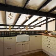 Image of kitchen designed by Debra DeLorenzo which cabinetry, ceiling, countertop, cuisine classique, daylighting, floor, interior design, kitchen, room, under cabinet lighting, wood, brown