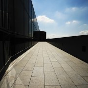 Image featuring paving done by Sam the Paving angle, architecture, atmosphere, building, cloud, daylighting, daytime, fixed link, horizon, infrastructure, landmark, line, reflection, road surface, sky, structure, sunlight, symmetry, wall, black, gray
