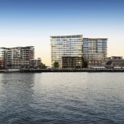 Exterior View of Brisbane's Portside Wharf development which architecture, building, city, cityscape, condominium, daytime, evening, horizon, marina, metropolis, real estate, reflection, residential area, river, sea, sky, skyline, skyscraper, tower block, urban area, water, waterway, white