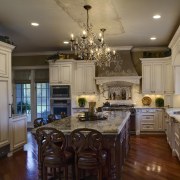 View of a kitchen which is centrally located cabinetry, ceiling, countertop, cuisine classique, dining room, home, interior design, kitchen, living room, room, brown