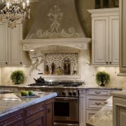 View of a kitchen which is centrally located cabinetry, countertop, cuisine classique, flooring, hardwood, home, interior design, kitchen, room, under cabinet lighting, brown