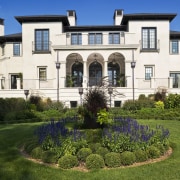 Exterior view of Renaissance styled home with stucco building, cottage, estate, facade, historic house, home, house, landscaping, lawn, mansion, property, real estate, residential area, villa, brown