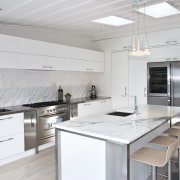 View of the kitchen and dining room where countertop, cuisine classique, interior design, kitchen, real estate, white, gray