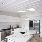 View of the kitchen and dining room where ceiling, countertop, daylighting, interior design, kitchen, gray, white