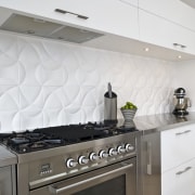 View of the kitchen and dining room where cabinetry, countertop, cuisine classique, floor, flooring, interior design, kitchen, kitchen stove, tile, white