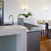 View of kitchen and dining area which features countertop, floor, flooring, furniture, home, interior design, kitchen, product design, room, table, gray, white