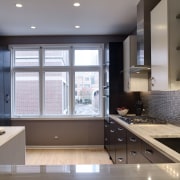 View of a remodelled kitchen which is adjacent cabinetry, countertop, daylighting, interior design, kitchen, room, gray