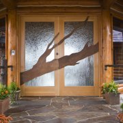 Image of unique designs on glass doors created door, floor, flooring, hardwood, home, house, interior design, outdoor structure, porch, real estate, wall, window, wood, wood stain, brown