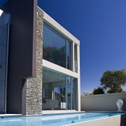 Exterior view of house and pool area with architecture, building, daylighting, estate, facade, home, house, property, real estate, residential area, sky, swimming pool, villa, window, blue