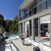 View of patio with water and sun resistant apartment, architecture, building, condominium, estate, facade, home, house, mixed use, property, real estate, residential area, window, gray