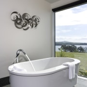 Image of the bathroom, featuring a white bathtub. angle, bathroom, bathtub, interior design, plumbing fixture, product design, tap, toilet seat, gray