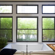 View of bathtub which is set into a daylighting, home, interior design, real estate, sash window, window, window covering, window treatment, wood, black