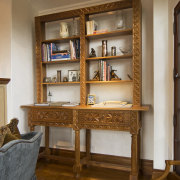 Image of the woodwork incorporated into this home. bookcase, cabinetry, display case, floor, flooring, furniture, interior design, living room, shelf, shelving, table, brown