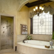View of bathtub with stone tiled surround, chandelier bathroom, ceiling, estate, floor, flooring, home, interior design, room, window, brown, orange