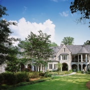 Image of the exterior of this home designed architecture, cloud, cottage, estate, facade, farmhouse, garden, grass, historic house, home, house, landscape, landscaping, lawn, manor house, mansion, national trust for places of historic interest or natural beauty, plantation, property, real estate, residential area, sky, stately home, suburb, tree, villa, black