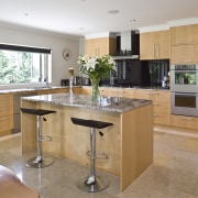 View of a kitchen designed and manufactured by cabinetry, countertop, cuisine classique, floor, flooring, interior design, kitchen, real estate, room, orange, gray