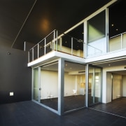 View of a access corridor inside the Coda architecture, building, daylighting, estate, facade, glass, handrail, home, house, interior design, lighting, property, real estate, stairs, window, black