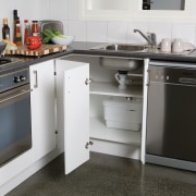 Image of a kitchen which has a macerating countertop, floor, flooring, furniture, home appliance, kitchen, kitchen appliance, kitchen stove, major appliance, white, gray, black