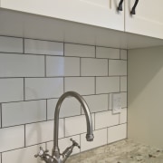 View of laundry, featuring a white butler's sink, bathroom, floor, flooring, plumbing fixture, product design, sink, tap, tile, wall, gray