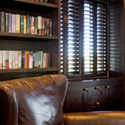 Image of dark stained library shelving and cabinetry bookcase, furniture, interior design, library, shelving, window, black
