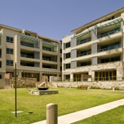 Exterior view of the Lindfield Apartments which feature apartment, architecture, building, campus, condominium, corporate headquarters, elevation, estate, facade, grass, home, mixed use, neighbourhood, property, real estate, residential area, brown