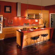 View of a custom kitchen which features cabinetry cabinetry, countertop, cuisine classique, dining room, floor, flooring, furniture, hardwood, home, interior design, kitchen, light fixture, lighting, room, table, under cabinet lighting, wood, wood flooring, red, brown