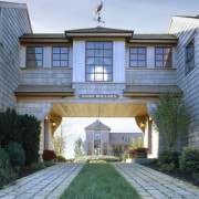 Exterior view of an enclosed bridge with shingle building, cottage, elevation, estate, facade, home, house, mansion, property, real estate, residential area, siding, window, teal