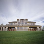 Exterior view of a large cottage with cedar cloud, cottage, elevation, estate, facade, farmhouse, grass, home, house, lawn, mansion, property, real estate, residential area, roof, sky, villa, gray