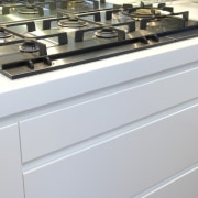 View of a gas cooktop which is part countertop, gray