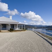 Exterior view of Victorian-syle house featuring steel roofing, cloud, coast, cottage, estate, home, house, mountain, property, real estate, sky, villa, water, gray