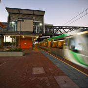 A new bus and train interchange is a architecture, evening, metropolitan area, public transport, rail transport, rapid transit, residential area, sky, track, train, train station, transport, urban area, vehicle