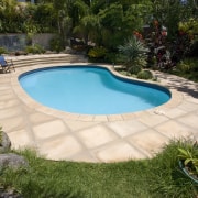 View of a pool with paving that features backyard, estate, landscape, landscaping, leisure, outdoor structure, property, swimming pool, yard, brown