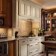 View of a kitchen which features cabinetry available cabinetry, countertop, cuisine classique, furniture, interior design, kitchen, room, under cabinet lighting, brown, orange
