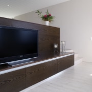 View of the television and living area with display device, flat panel display, floor, furniture, home, interior design, living room, media, multimedia, television, gray, black