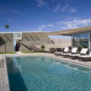 Exterior view of the outdoor area with pool, estate, home, house, leisure, property, real estate, reflection, resort, sky, swimming pool, villa, water, blue