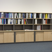 Image of desk and shelving supplied by The bookcase, furniture, institution, library, library science, product design, public library, shelf, shelving, white, gray