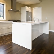 view of a show home kitchen where the cabinetry, countertop, floor, flooring, hardwood, home, interior design, kitchen, laminate flooring, property, real estate, room, wood, wood flooring, brown, gray