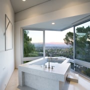 View of limestone bathtub with faucetry, tiled flooring, architecture, bathroom, ceiling, daylighting, estate, floor, home, house, interior design, real estate, window, gray