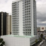 Exterior view of the entrance way of the apartment, architecture, building, commercial building, condominium, corporate headquarters, facade, headquarters, metropolis, metropolitan area, mixed use, real estate, residential area, tower block, white, gray