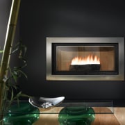 View of heat-efficient fireplace with cherry blossom surround fireplace, hearth, heat, wood burning stove, black