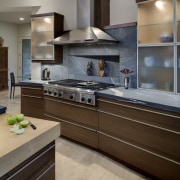 View of kitchen featuring kitchen island with 4 cabinetry, countertop, cuisine classique, floor, flooring, home appliance, interior design, kitchen, room, gray, brown