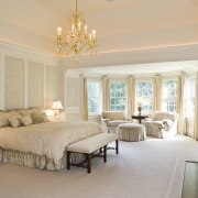 View of the master bedroom with chandelier overhead, bed frame, bedroom, ceiling, estate, floor, home, interior design, living room, property, real estate, room, suite, wall, window, gray, orange