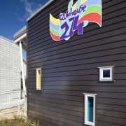 Exterior view of Clubhouse 274 which was built building, facade, house, real estate, siding, black